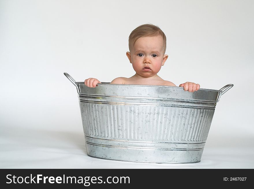 Image of cute baby sitting in a galvanized tub. Image of cute baby sitting in a galvanized tub