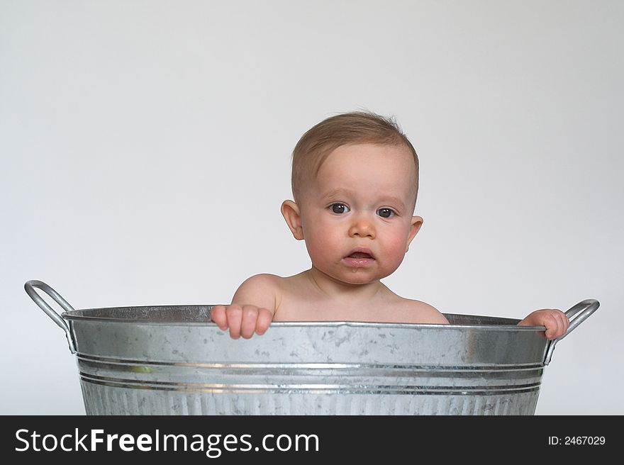 Image of cute baby sitting in a galvanized tub. Image of cute baby sitting in a galvanized tub