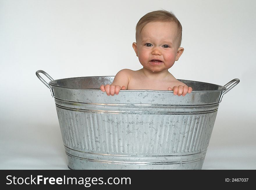 Image of cute baby sitting in a galvanized tub. Image of cute baby sitting in a galvanized tub