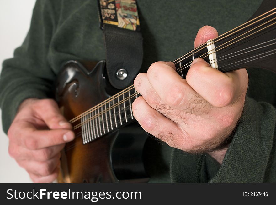 Close up of man playing guitare over white background. Close up of man playing guitare over white background