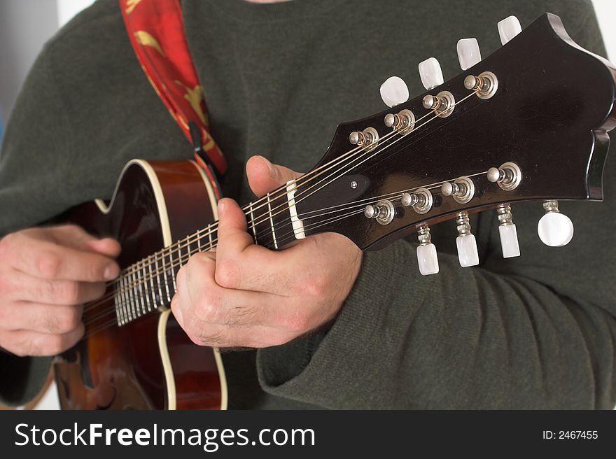Close up of man playing guitare over white background