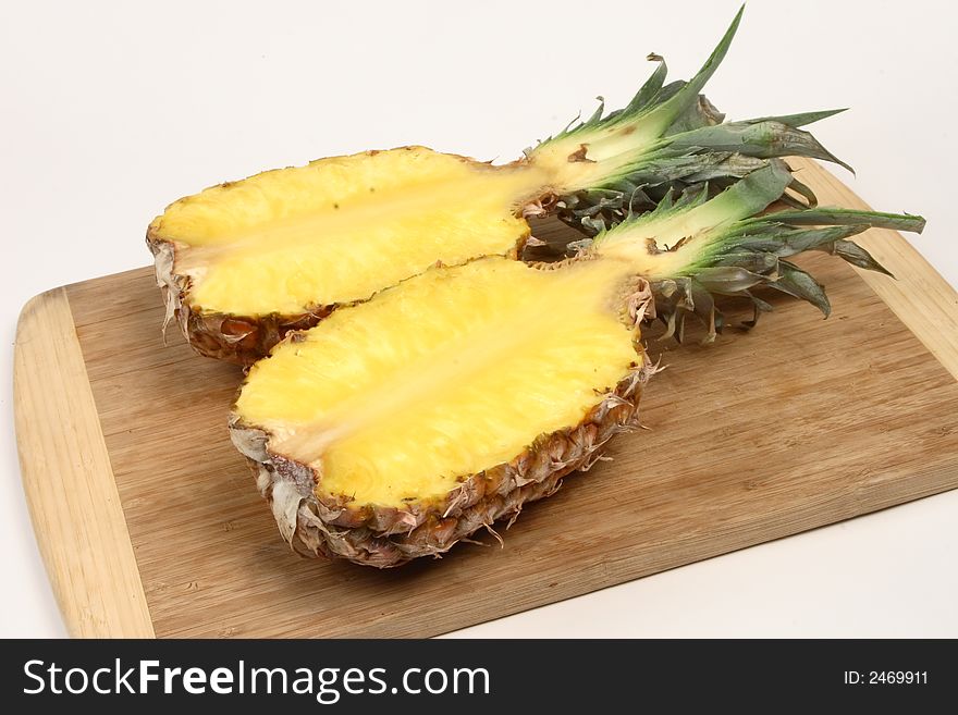 Ripe sliced pineapple on a cutting board
