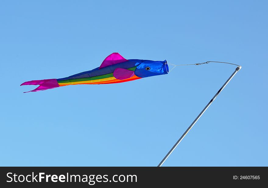 Colorful fish kite flying in blue sky