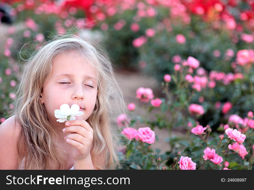 Girl enjoys the smell of flowers. Girl enjoys the smell of flowers