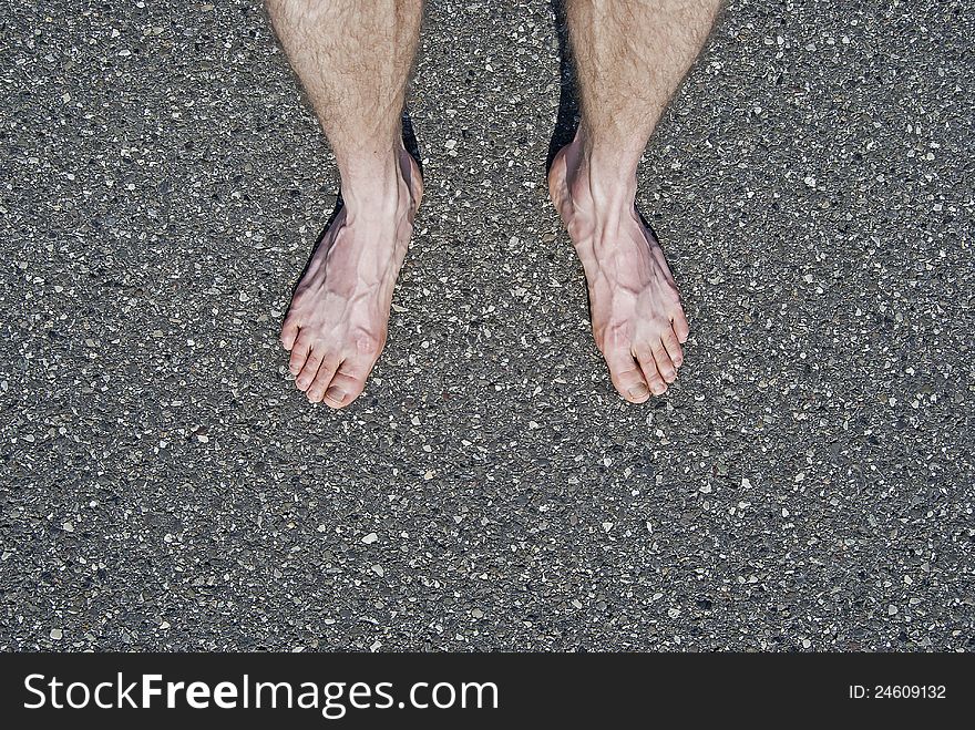 Close-up of male bare feet on cement horizontal shot. Close-up of male bare feet on cement horizontal shot