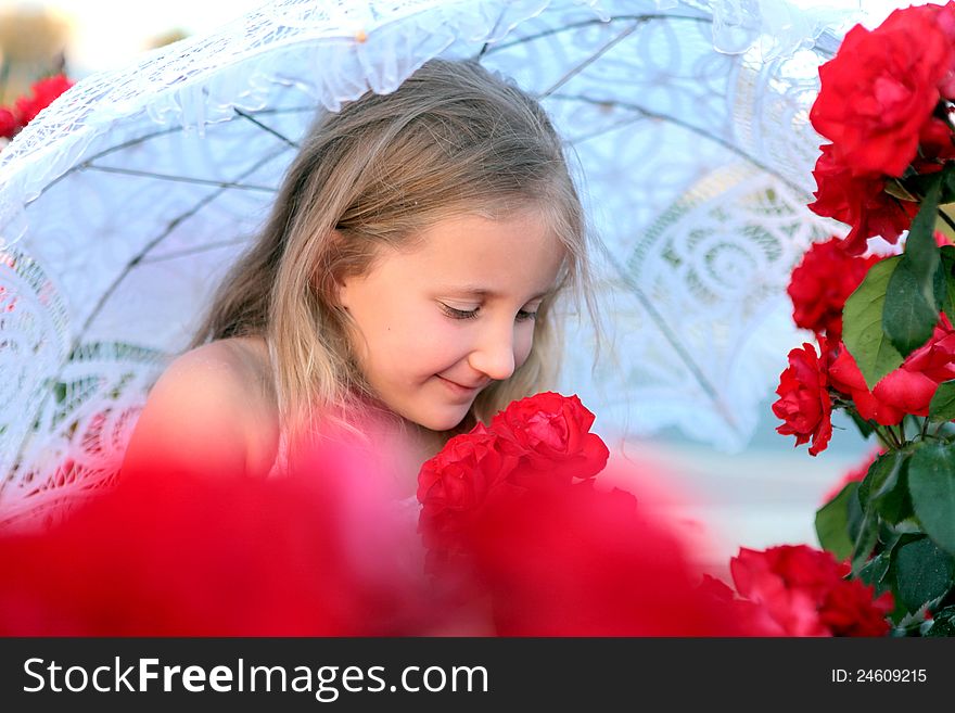 Girl with umbrella resting in the flowers. Girl with umbrella resting in the flowers