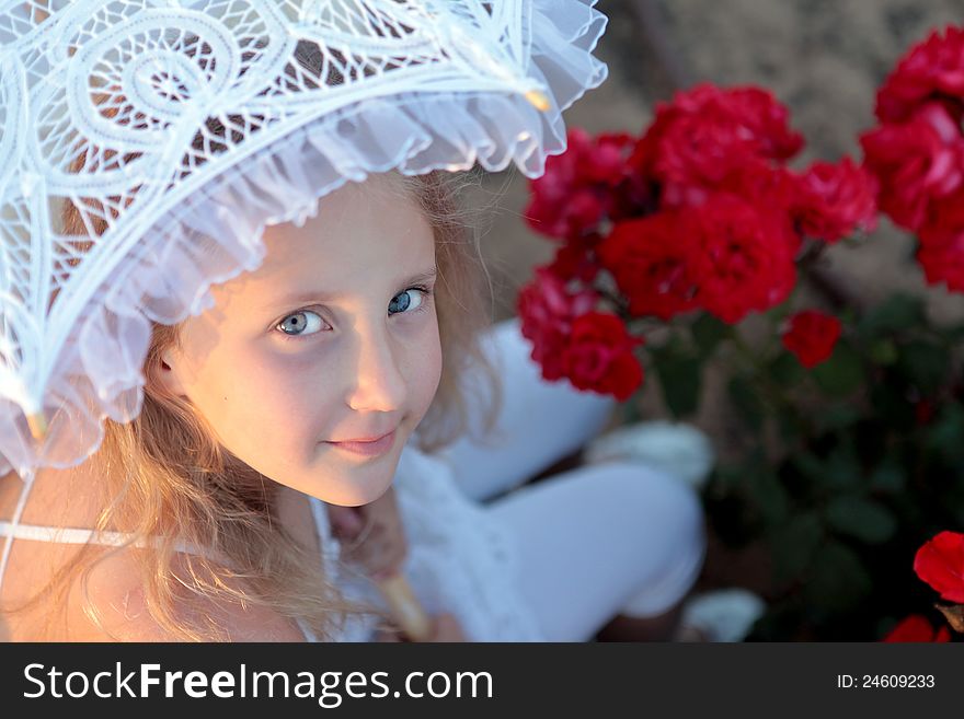 Girl looks out from under the lace parasol day