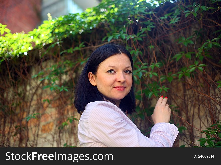 Brunette On A Background Of Climbing Plants