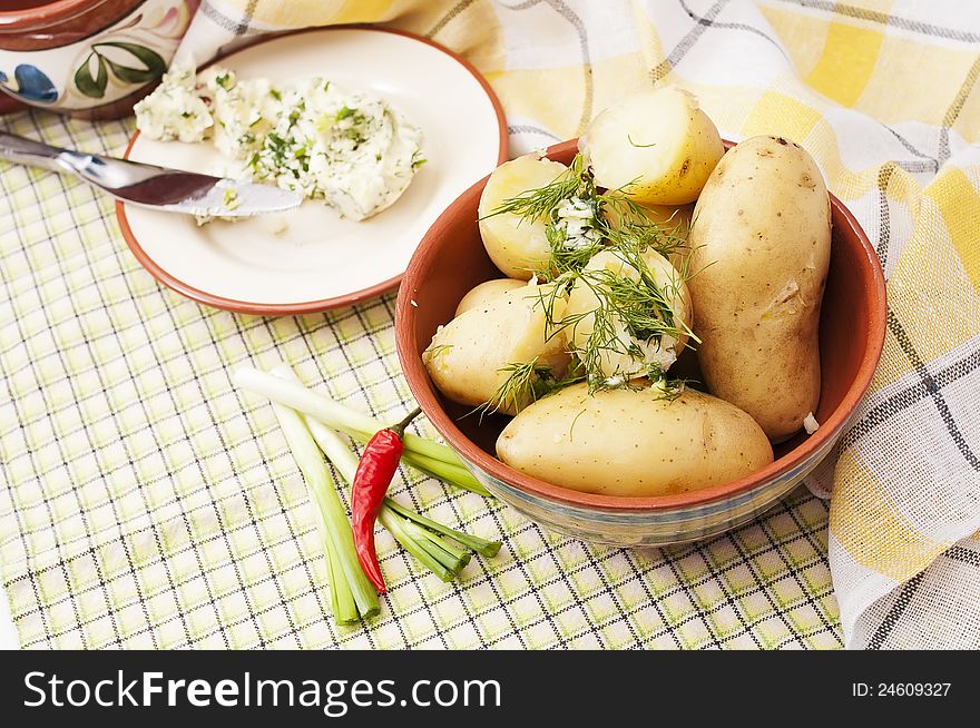 Boiled brown potatoes with the green butter