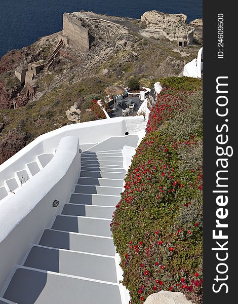 Alley with steps going downwards on the volcanic caldera at Santorini island in Greece