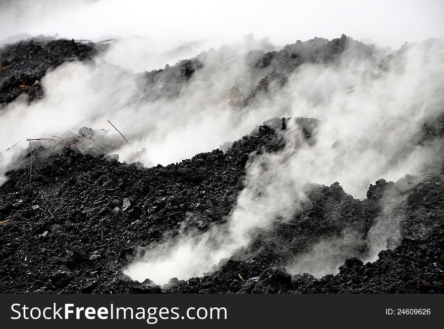 Charcoal pile burning in the outdoors, Romania