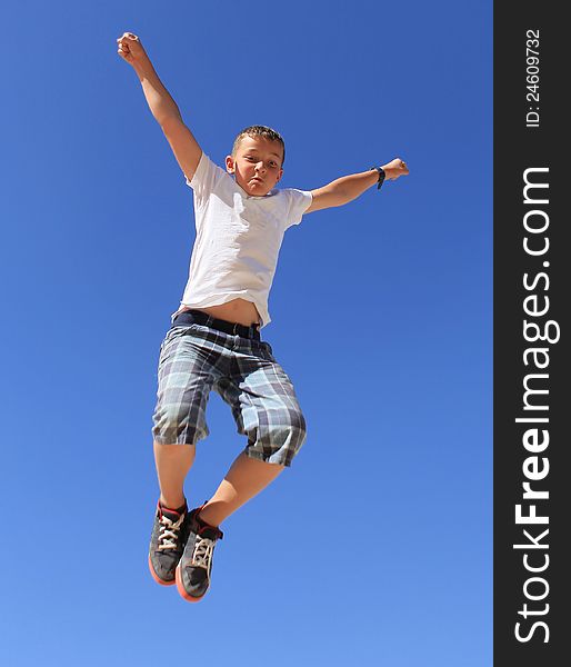 Boy jumping on a background of clear sky. Boy jumping on a background of clear sky