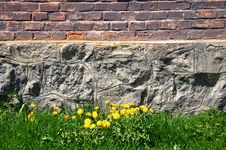Brick And Stone Wall, Grass And Dandelions Stock Photos Brick And Stone Wall, Grass And Dandelions Stock Photos