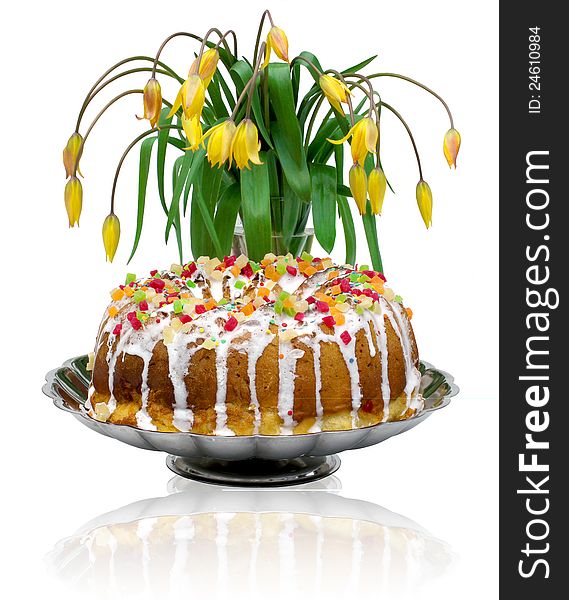 The composition of the biscuit cake and yellow tulips. The composition of the biscuit cake and yellow tulips