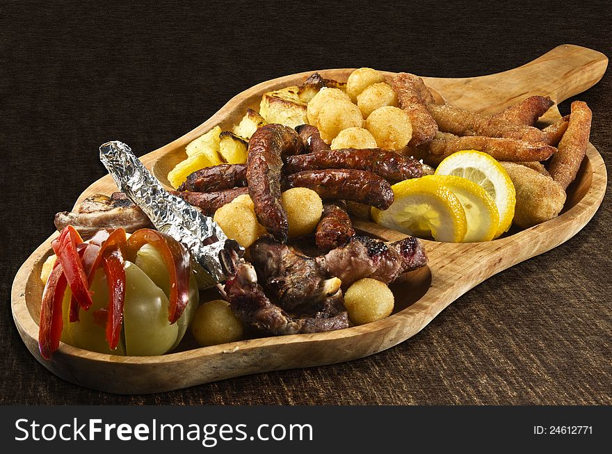 Rustic tray with various meats, cheese balls and assorted vegetables -