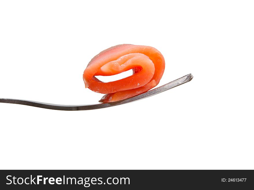 Roll of salmon slice on a fork, isolated on white