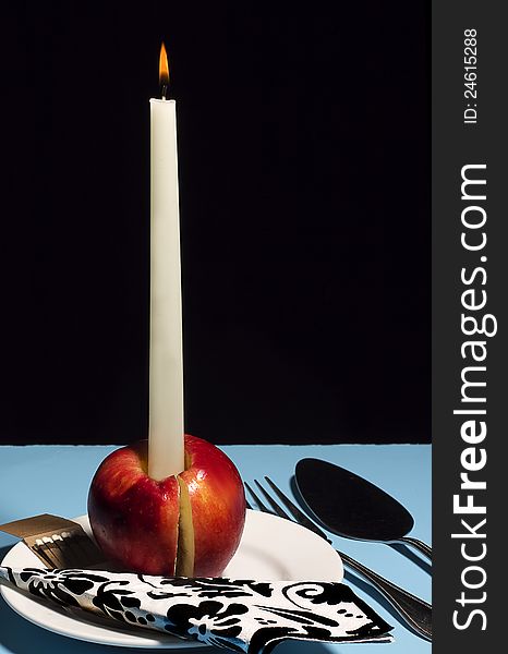 Concept, candle apple with serving utensils (Candy Apple Concept)