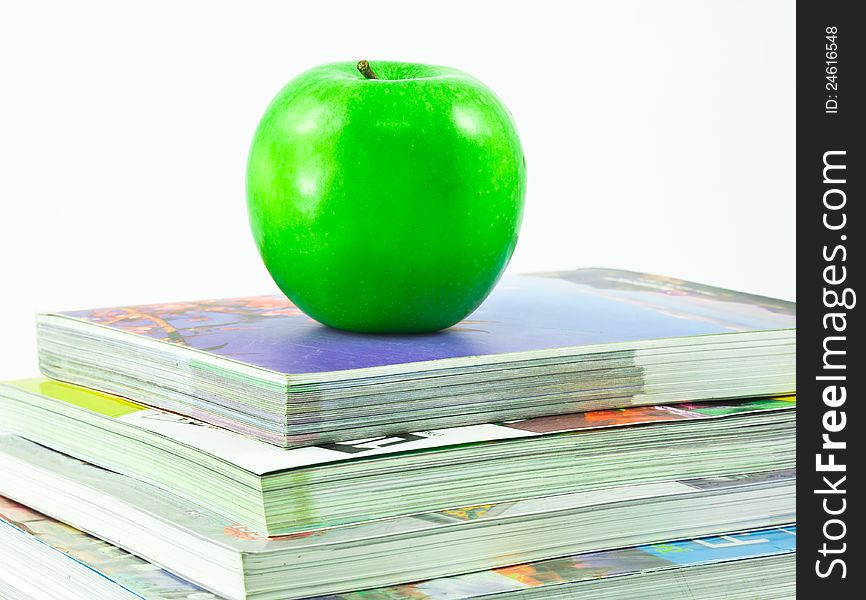 Books and an apple on top
