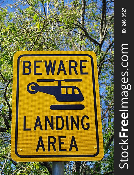 Yellow warning sign for helicopter landing area. Yellow warning sign for helicopter landing area