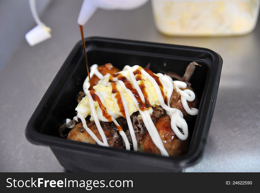 A person is being produced takoyaki