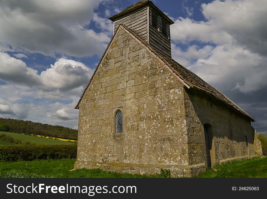 An ancient English chapel built by the Normans still standing proud in an English country field