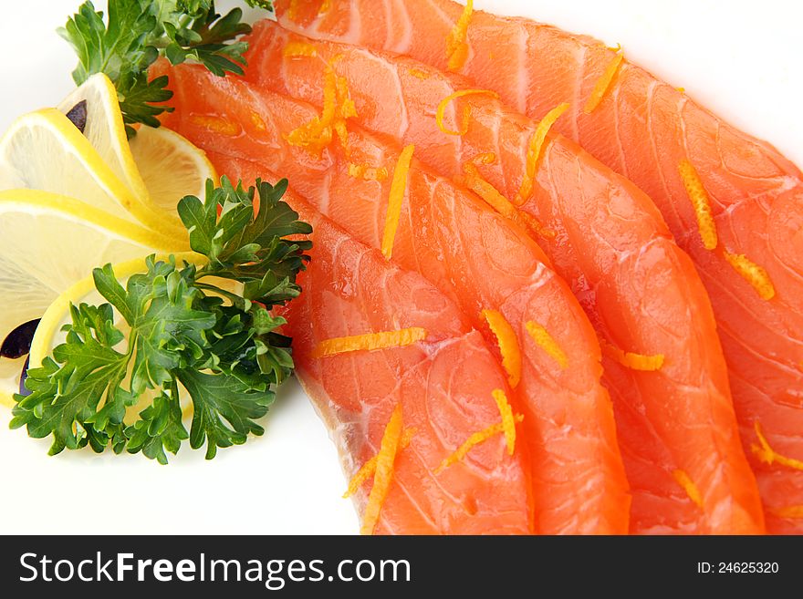 Slices of salmon with lemon on white background close up. Slices of salmon with lemon on white background close up