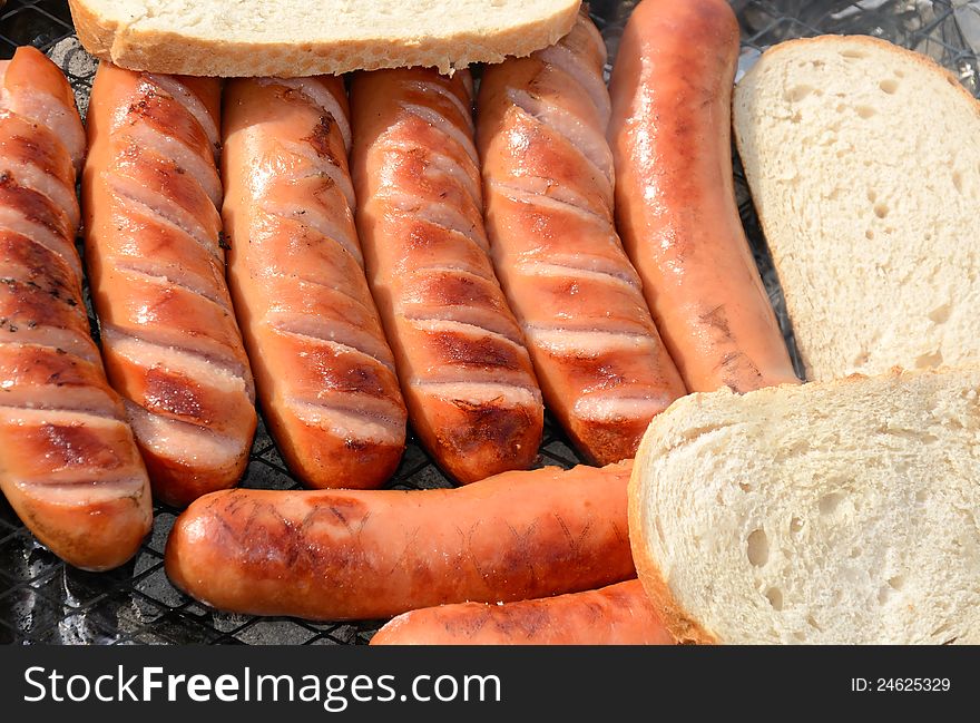 Closeup for grilled sausages with bread. Closeup for grilled sausages with bread