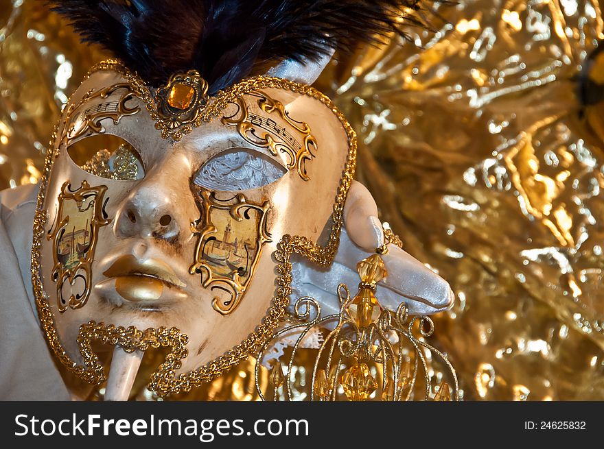 Carnival mask resting on his hand. Carnival mask resting on his hand