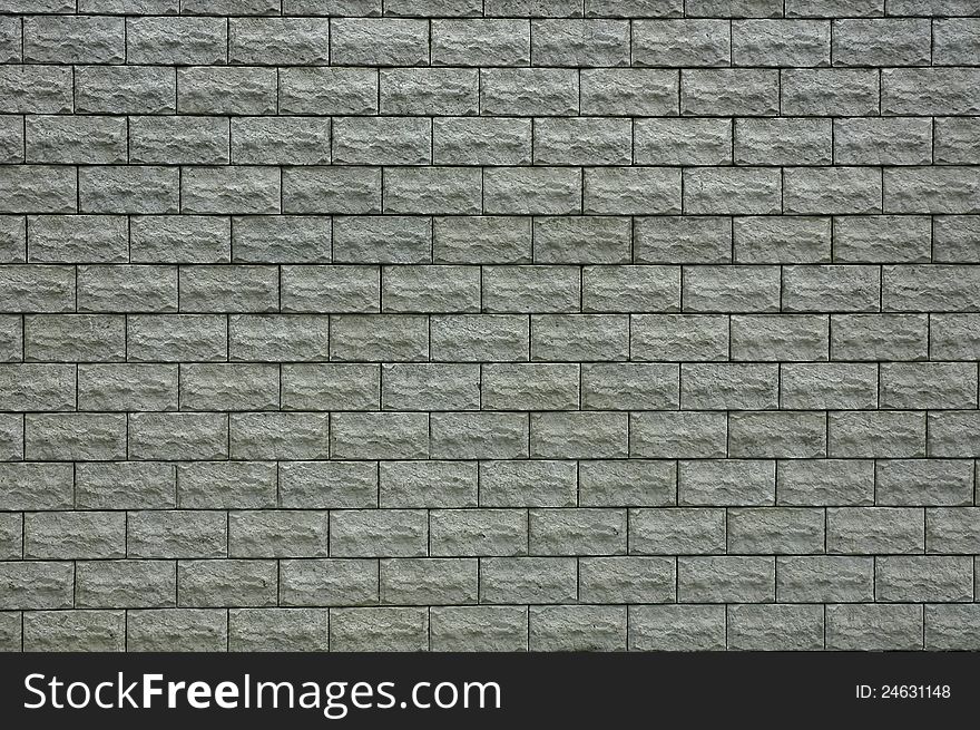 A background with a wall made of a pattern of gray tiles. A background with a wall made of a pattern of gray tiles.