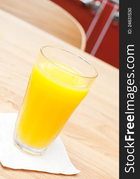 A glass of orange juice on a table