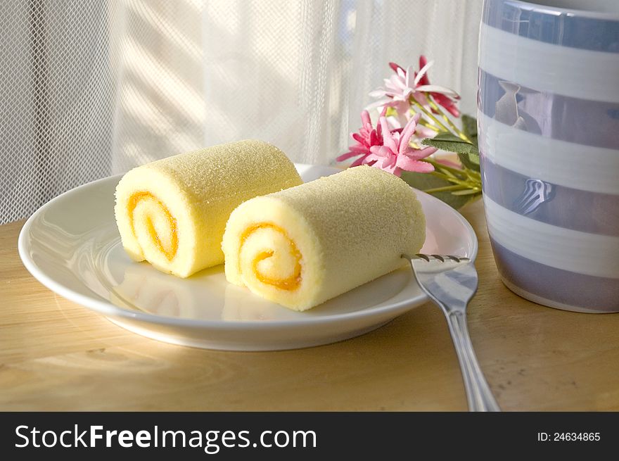 Roll cake set put on table with sunlight at noon. Roll cake set put on table with sunlight at noon