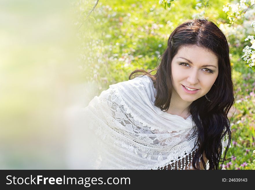 Image of a beautiful girl in the park against the backdrop of flowering trees