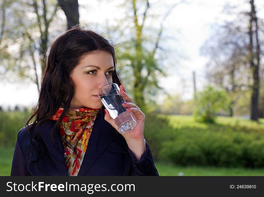 Young woman with glass of water, outdoors. Young woman with glass of water, outdoors