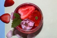 Drinking Glass Of Strawberry Juice With Strawberry And Two Flower Head As Decoration, One Flower Red The Other White Around The Ca Stock Photo