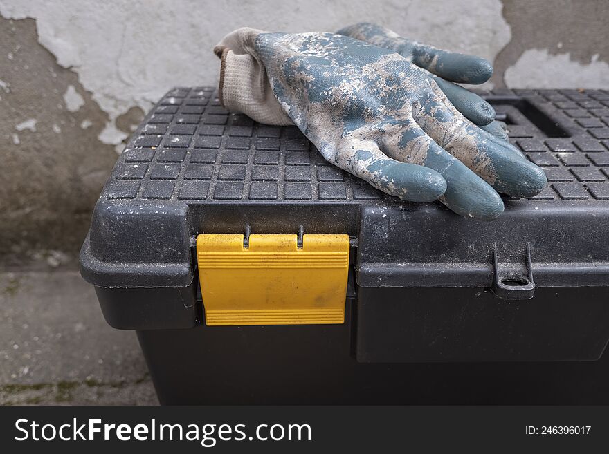 Discarded work gloves on a tool box