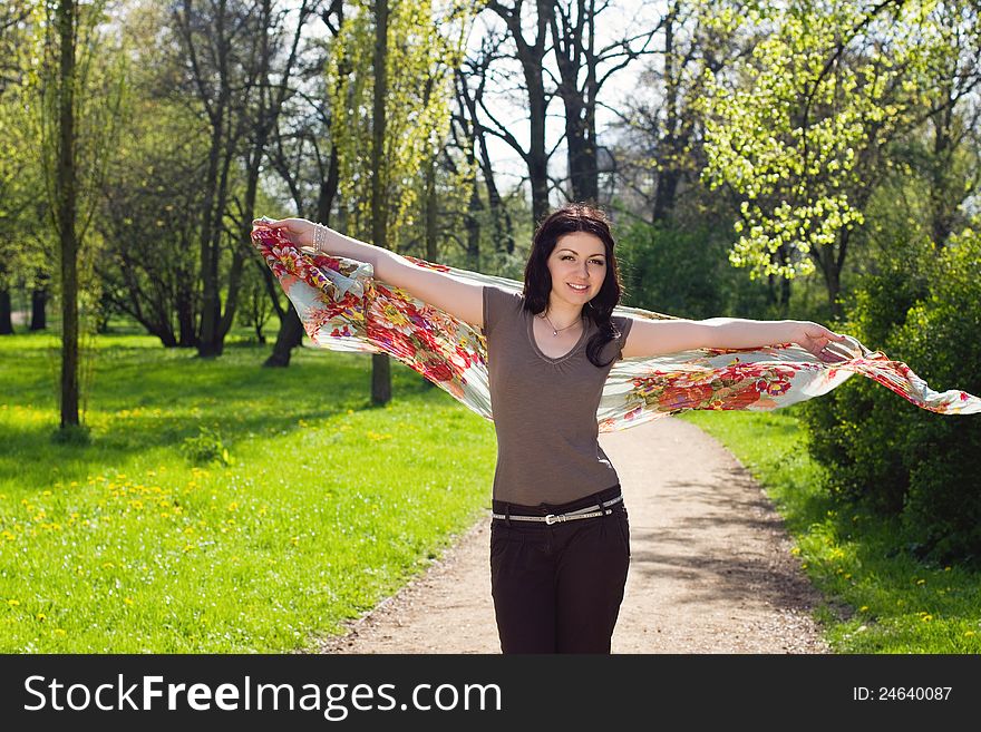 Pretty young brunette woman walking with flowered shawl. Pretty young brunette woman walking with flowered shawl