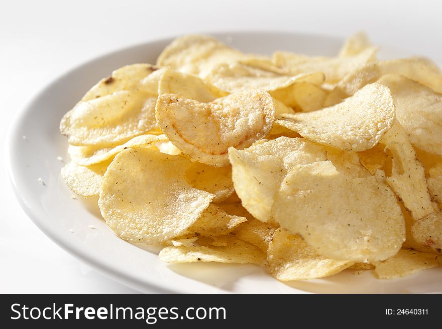 Some potato chips on the white plate