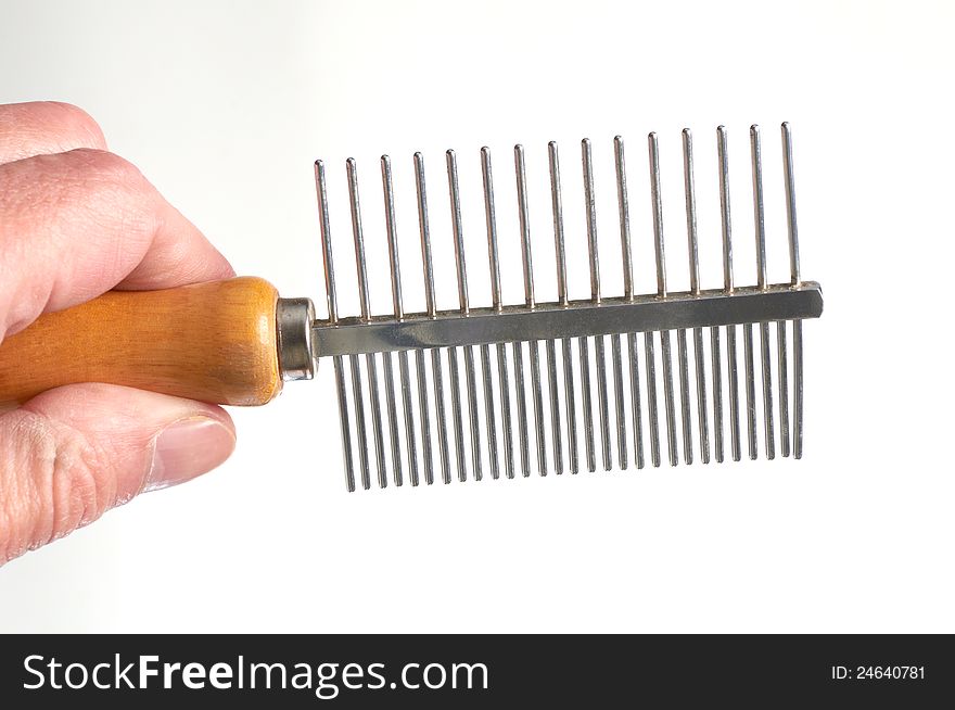 Hairbrush for animals in a hand isolated