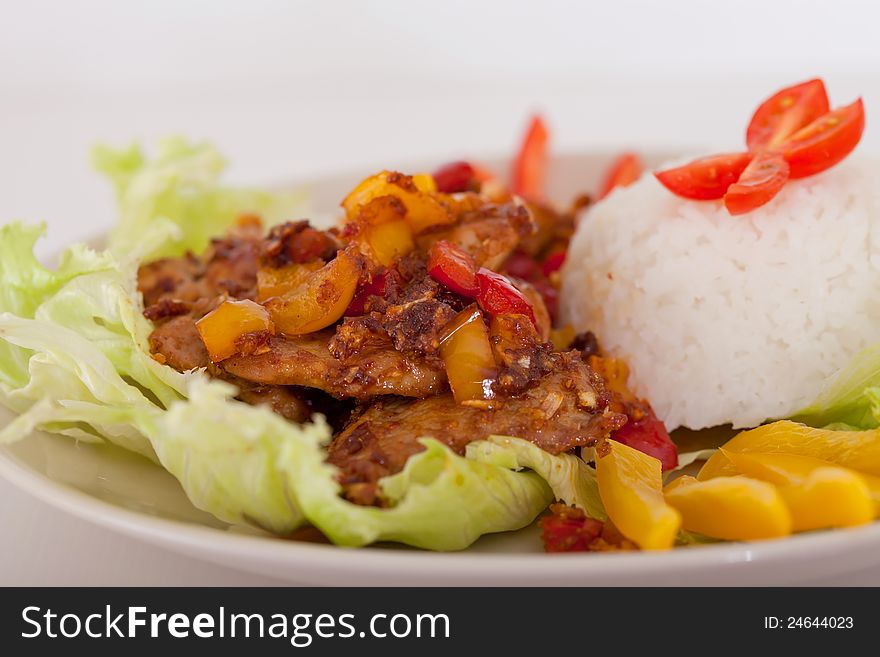 Fried pieces of pork  with rice