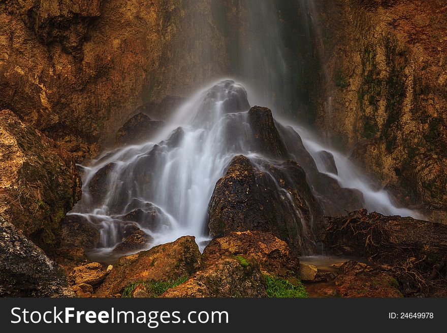 Peacefully flowing stream and waterfalls in the forest in the mountains