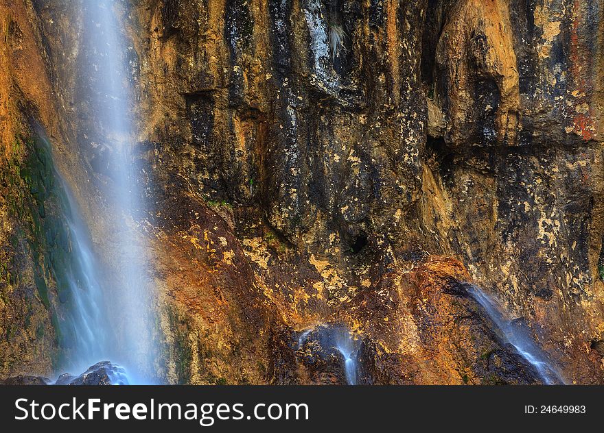 Peacefully flowing stream and waterfalls in the forest in the mountains