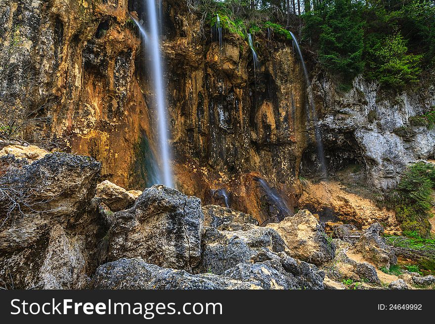 Peacefully flowing stream and waterfalls in the forest in the mountains