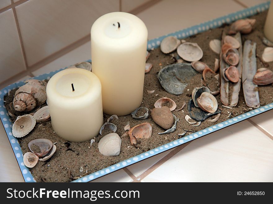 Decoration for the bathroom with candles, sand and various shells. Decoration for the bathroom with candles, sand and various shells