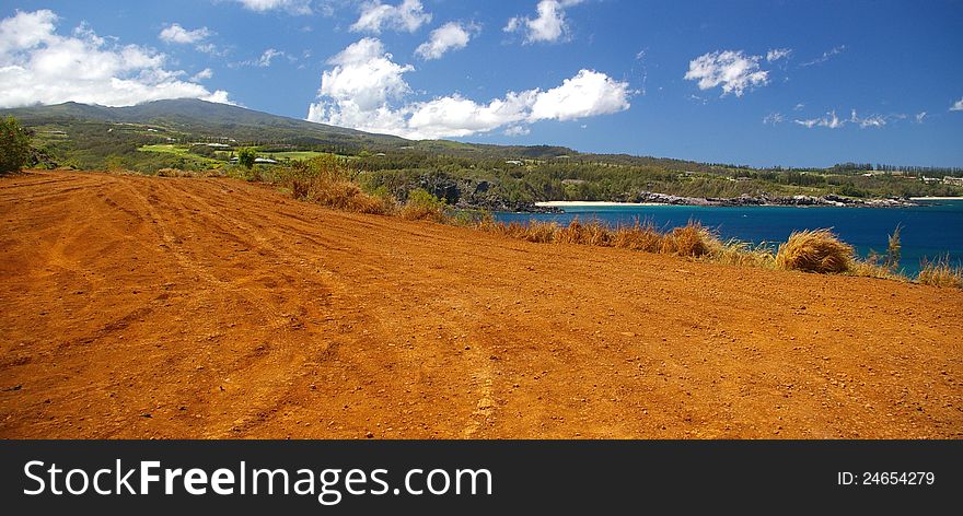 A natural dirt road along the coastline of Maui found to be traveled and enjoyed by tourists. A natural dirt road along the coastline of Maui found to be traveled and enjoyed by tourists