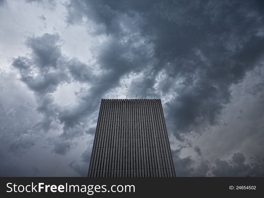 Skyscraper under a stormy clouds