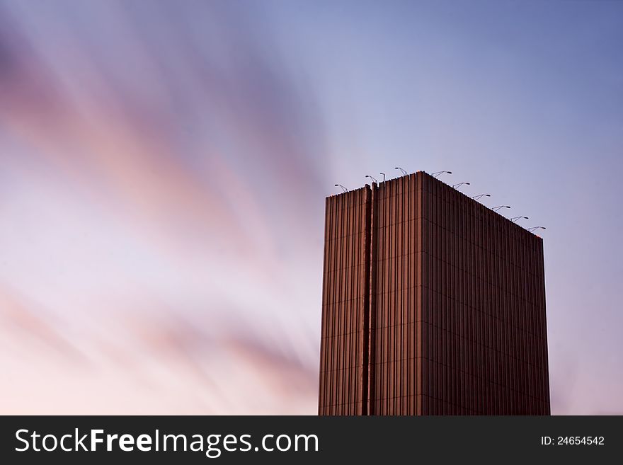 Skyscraper in Kiev, Ukraine, towering high under motion blured clouds. Horizontal with copy space. Skyscraper in Kiev, Ukraine, towering high under motion blured clouds. Horizontal with copy space.