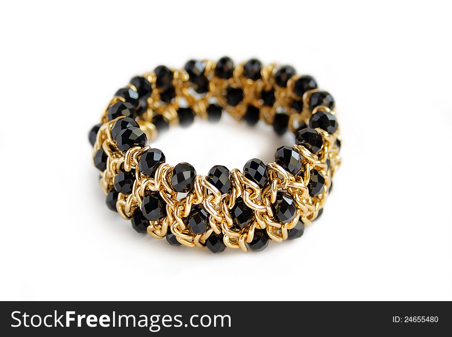 Beautiful golden bracelet with black stone on on white. Beautiful golden bracelet with black stone on on white