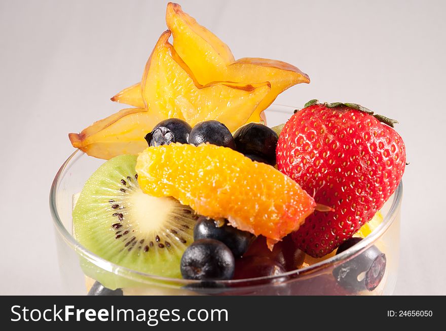 Fruit bowl with starfruit strawberry grapes blueberry orange kiwi. Fruit bowl with starfruit strawberry grapes blueberry orange kiwi