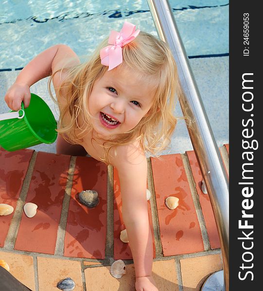 Little girl playing in a swimming pool