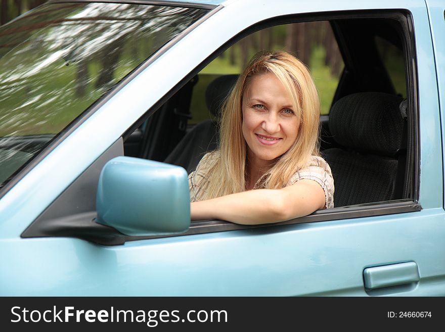 Smiling Young  Woman In The Car